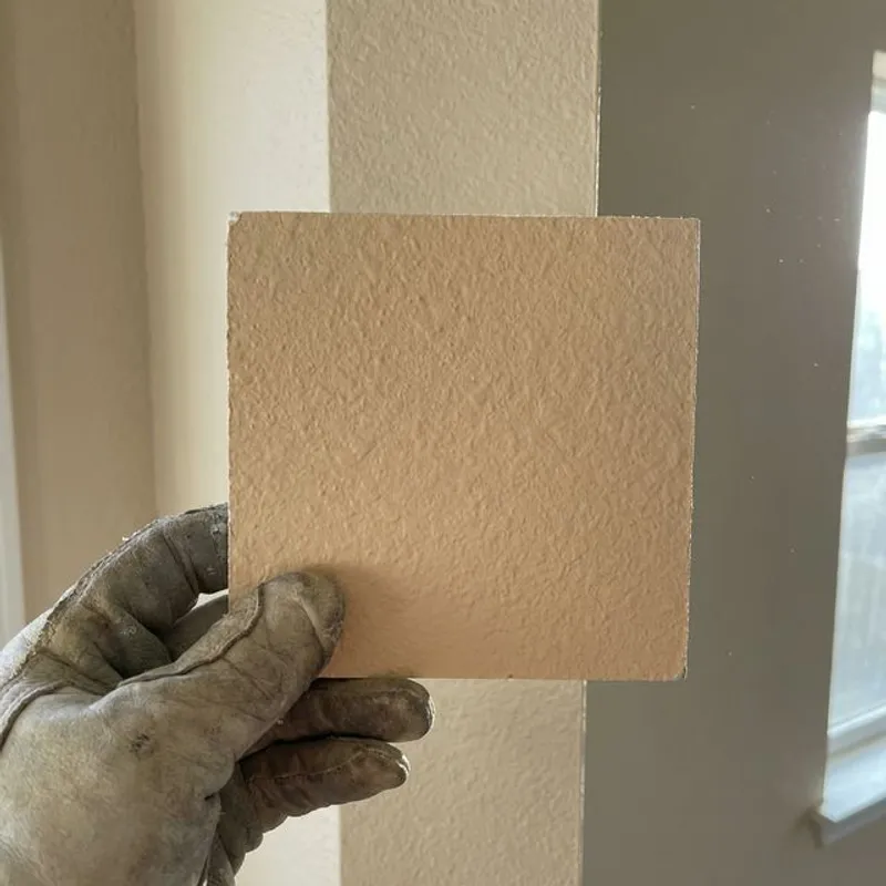 Drywall texture matching comparison on sample board showing blending technique