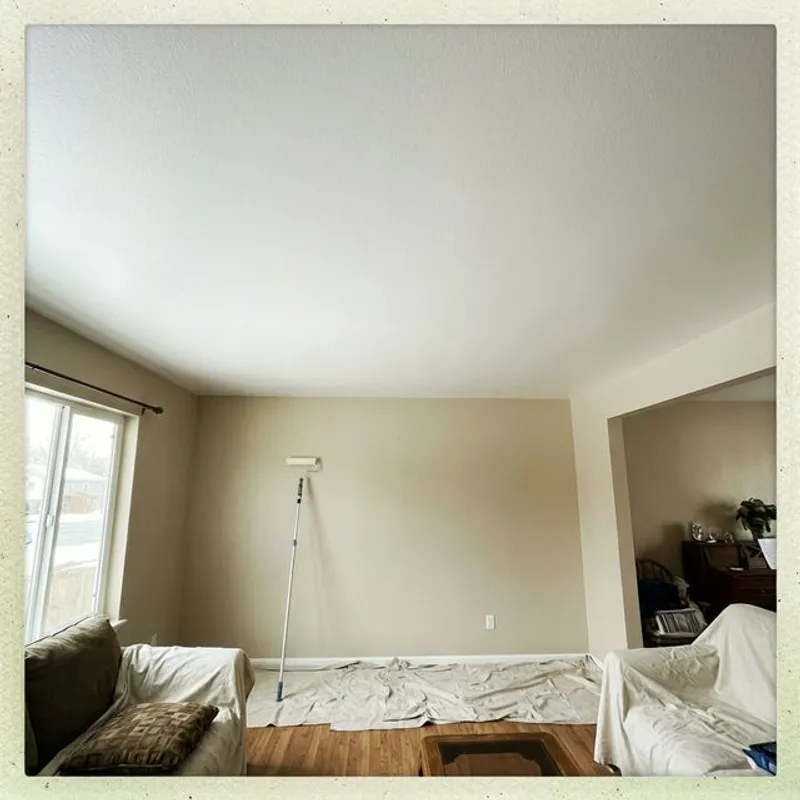 Smooth modern ceiling finish after popcorn texture removal and painting